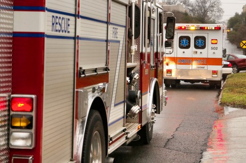 A firetruck and ambulance by the side of the road