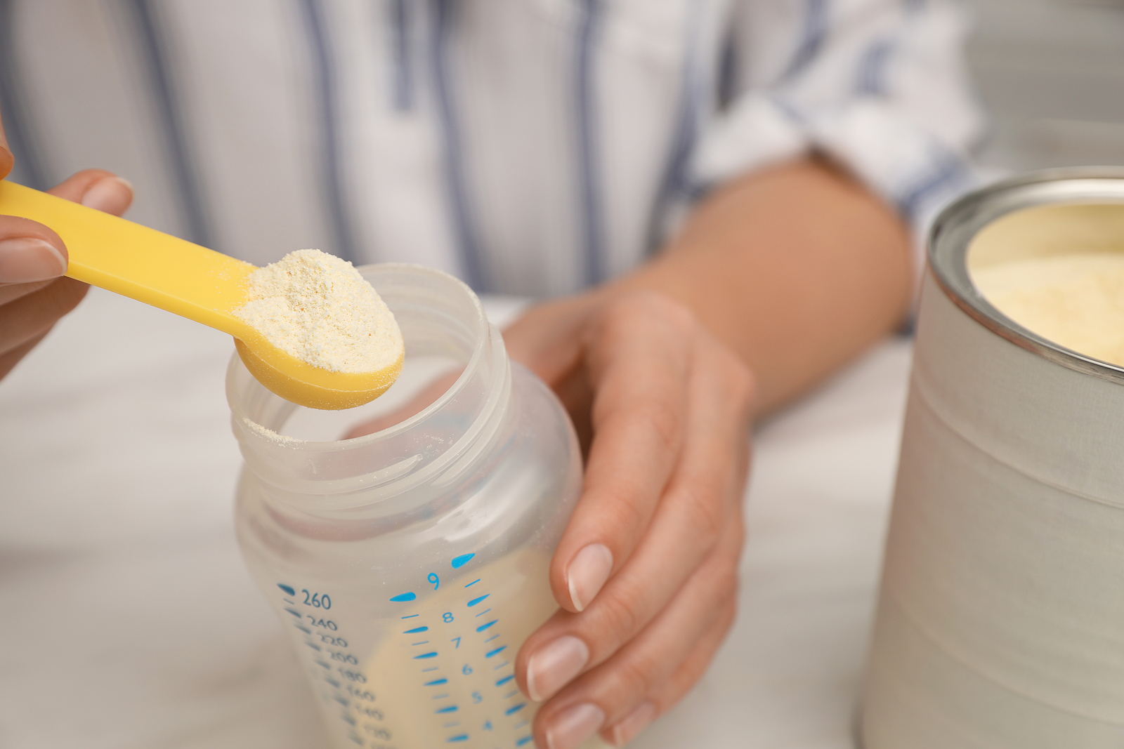 bigstock-Woman-Preparing-Infant-Formula-448916939